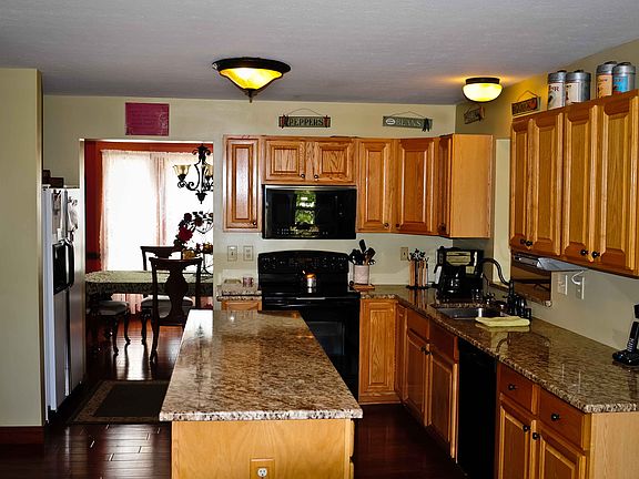granite counter tops, lots of cabinets and hardwood floors