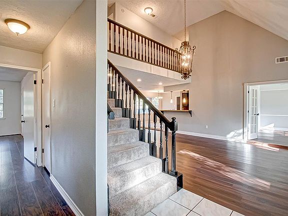 Entry is very open to living. Master suite descretely tucked behind stair well