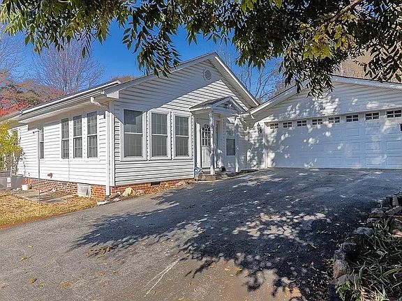 Off street parking with two car garage and workshop/storage area