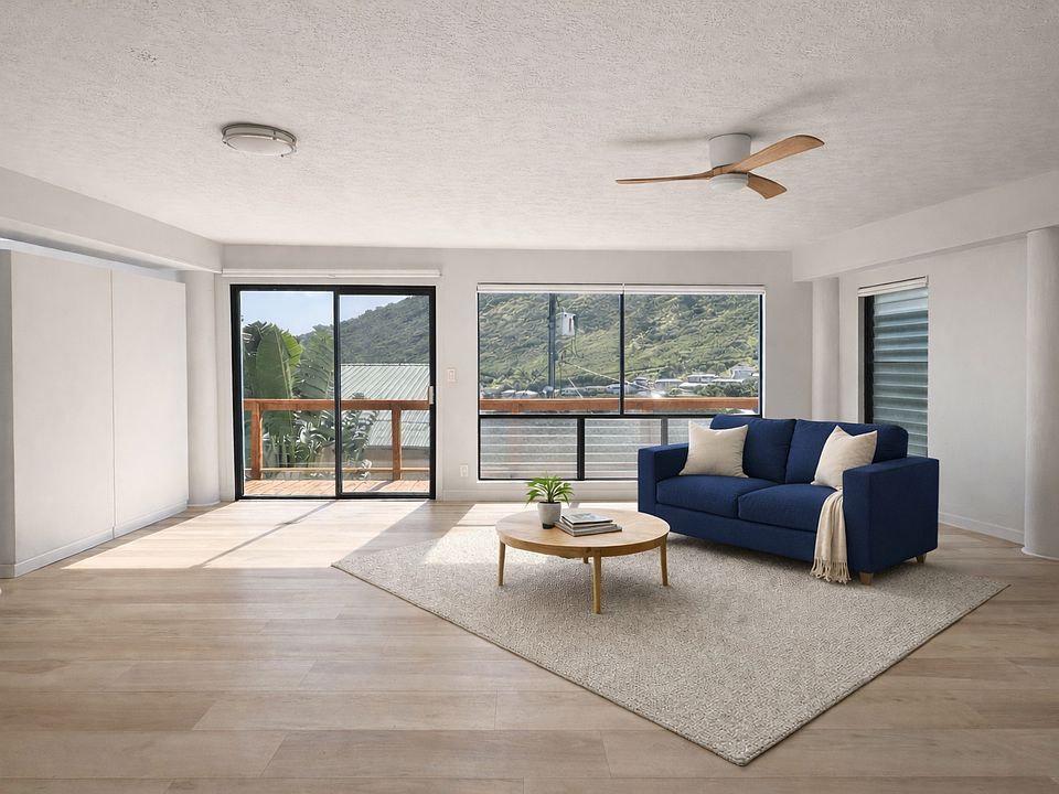 Living room- with an outdoor deck facing beautiful Aina Haina Valley. Room is staged and rented unfurnished.