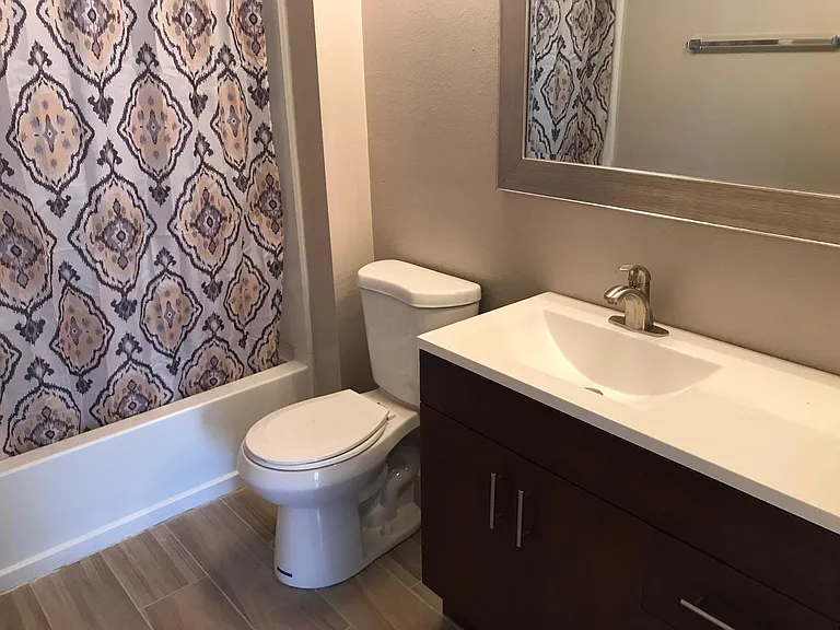 Guest bath w/decorative curtain.