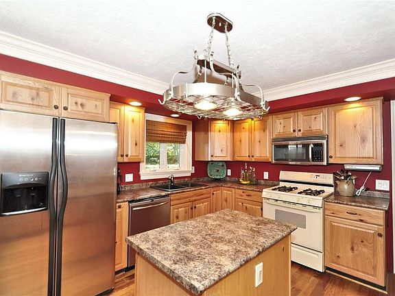 Renovated kitchen; center island, stainless steel appliances.