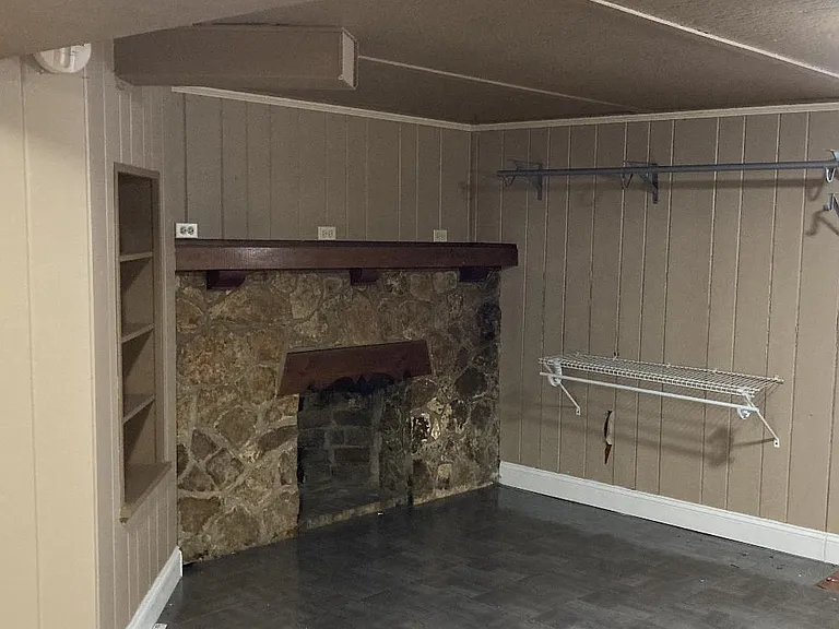 Family room downstairs with faux fireplace
