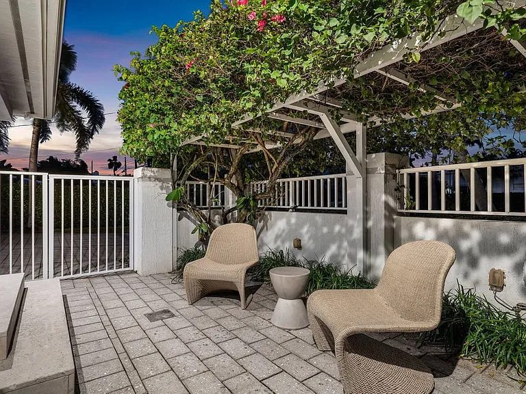 Unwind in a private garden nook, surrounded by lush greenery and soft evening light.