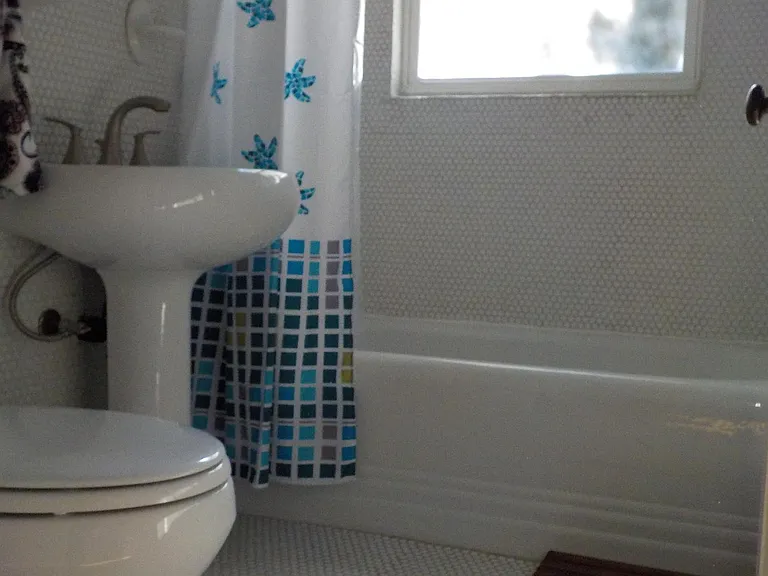 Bathroom has updated fixtures, the original 1939 tub, and penny tiles (not as old) from floor to ceiling.
