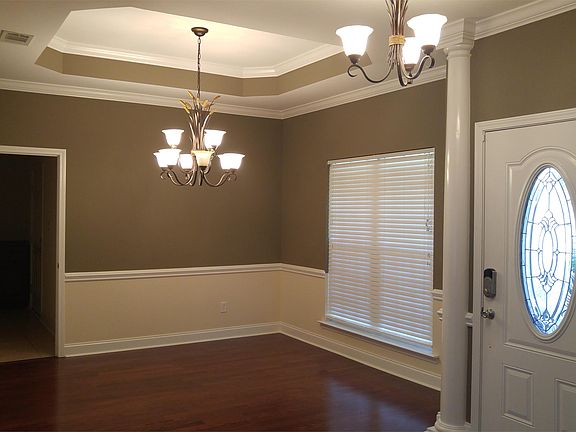 Dining room with tray ceiling and door to the laundry area and garage.