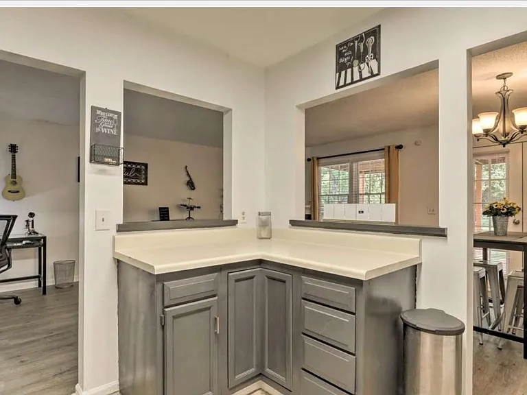 Kitchen has stainless steel appliances. and is open to the designated study/work area.