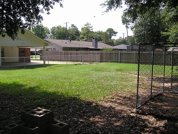 far back corner photo of the back yard and carport