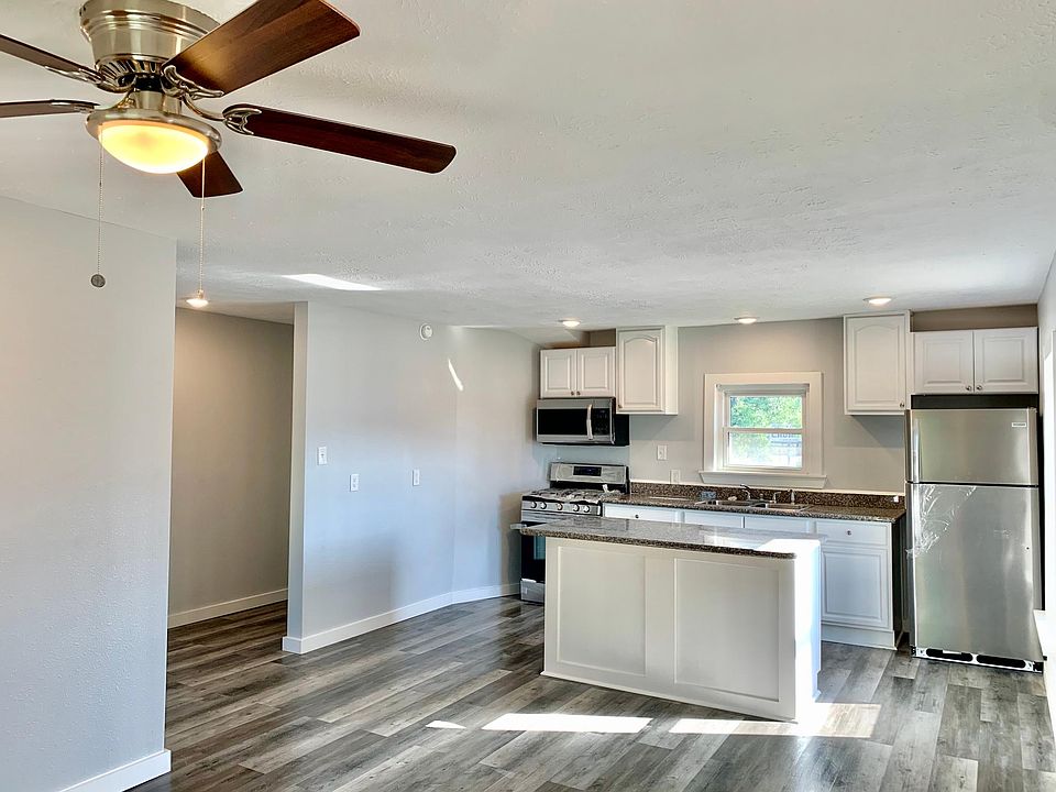 Beautiful Spacious Kitchen with granite counter tops including an island suitable for seating.