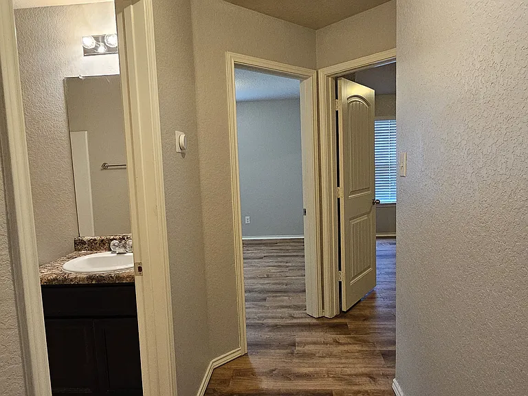 Looking into secondary bathroom, third bedroom and fourth bedroom.