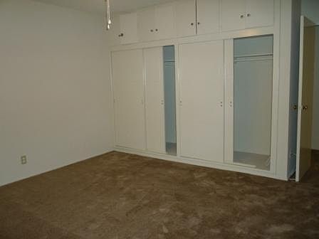 bedroom closet with storage above