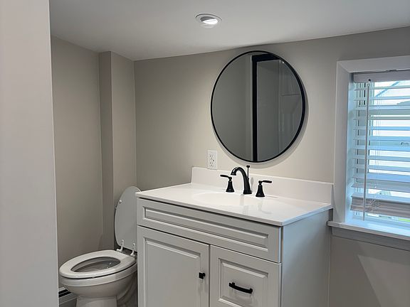 New vanity and toilet and shower with seat