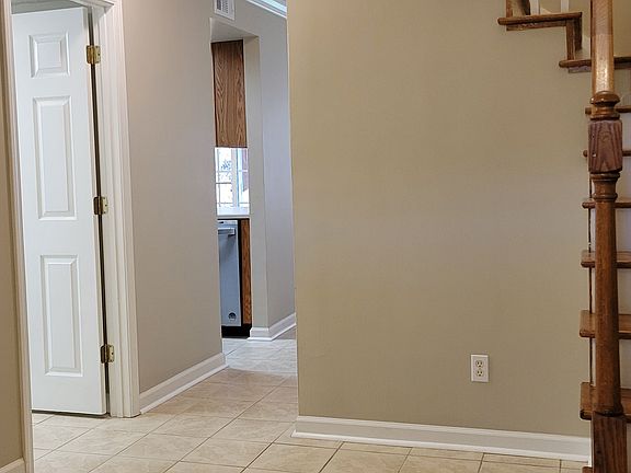 FRONT FOYER ENTRANCE. HALF BATH DOOR IS OPEN ON THE LEFT