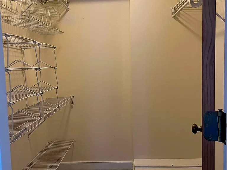 Primary bedroom walk-in closet