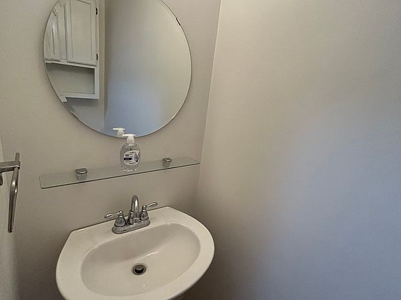 Powder room off living room and kitchen