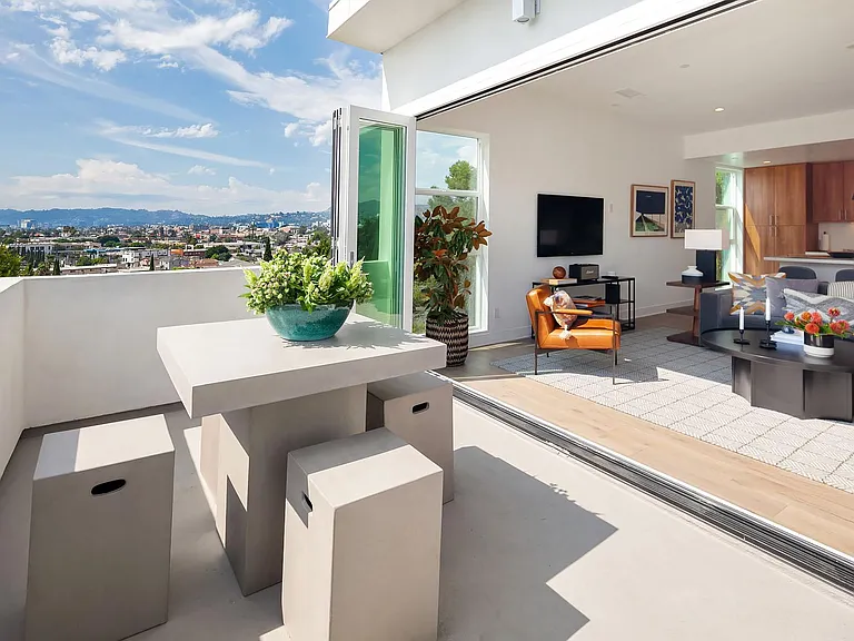 Living room (top floor) opens out to a sprawling balcony with stunning views of the Hollywood Sign, The Griffith Observatory, and surrounding Silver Lake hillsides.