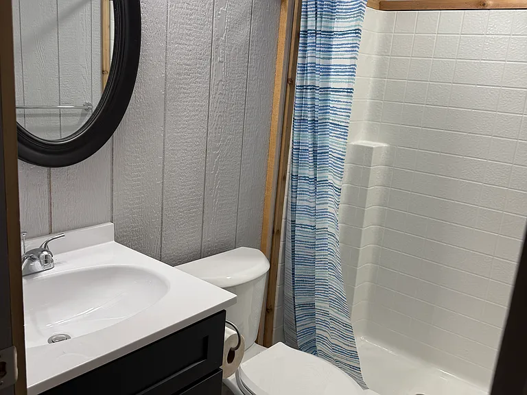 Hall bathroom toilet, shower, 30 inch vanity with lots of plugs.