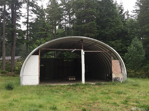Rigid aluminum carport with concrete floor. 32' long, 26' wide, 13' tall in center, (clear) 10' opening on the left. 