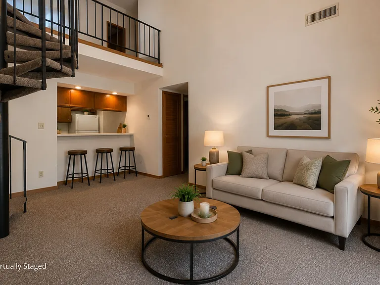 A spacious living area with loft-style design and an open floor plan offers the perfect blend of comfort and character.