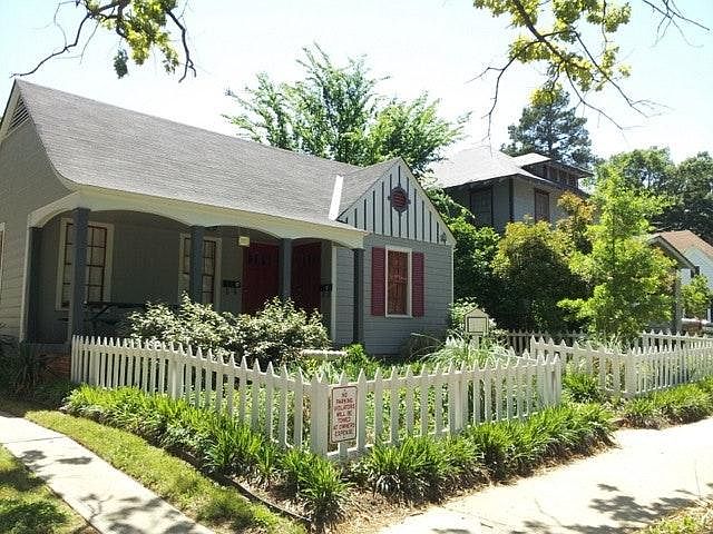 Picket fence, nicely landscaped. Picnic table front porch on quiet street.