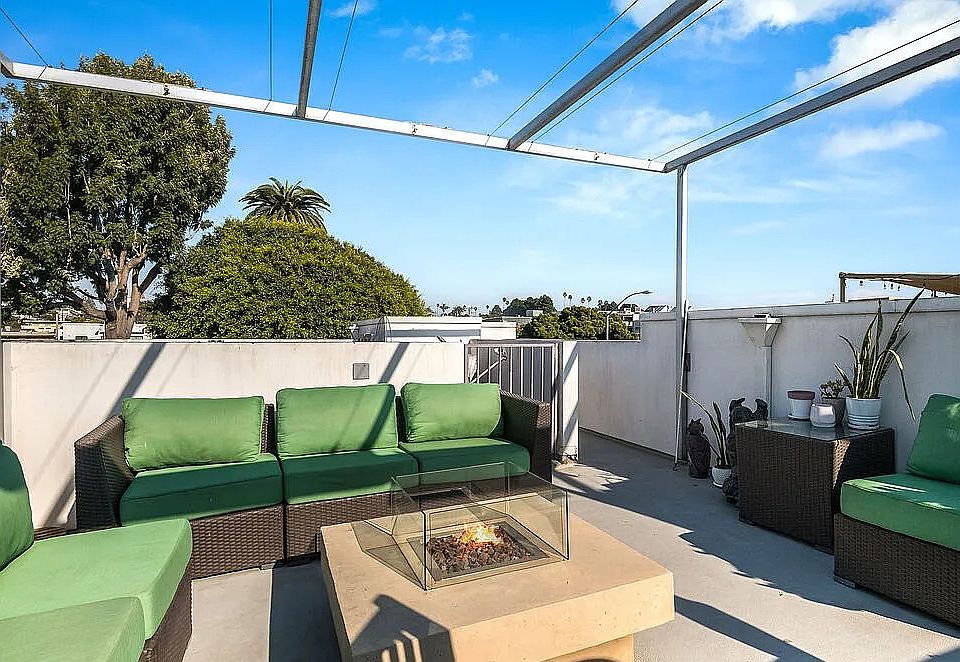 Plush, comfortable furniture adorns the rooftop, inviting ultimate indulgence in the ocean breeze and magnificent sunset views.
