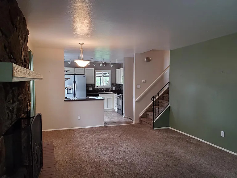 View of spacious kitchen from living room. House no longer has carpet - now has new luxury vinyl flooring.