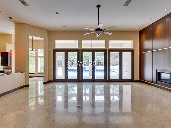 Enter into light and bright Great Room with marble floor and built in entertainment center and fireplace.  Patio doors open dire