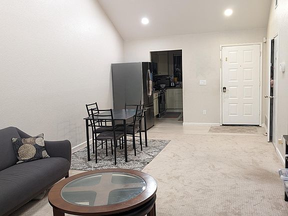 Living room facing kitchen and dinning