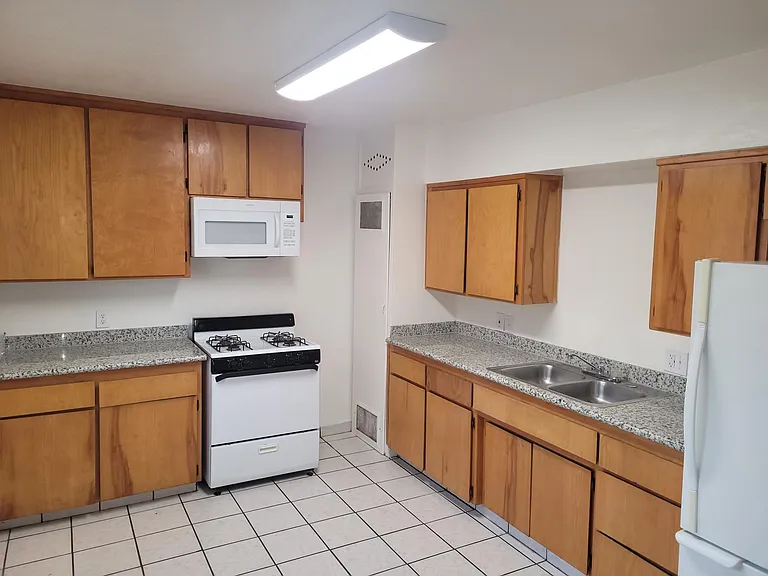 Kitchen with gas stove and built-in microwave oven