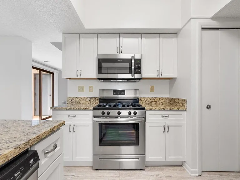 White kitchen with stainless steel appliance package