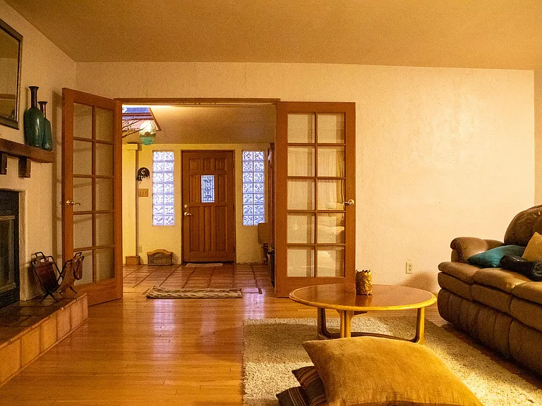 Living room and sunroom with front door at the far end
