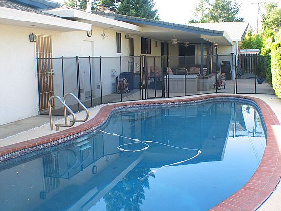 Covered patio with lighted ceiling fans, great for hosting parties