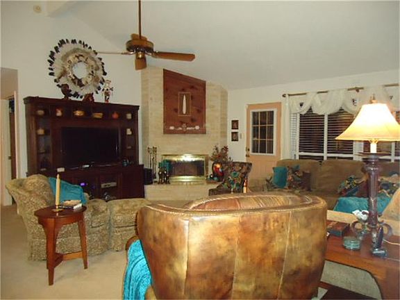 Large living room  with wood burning fireplace.