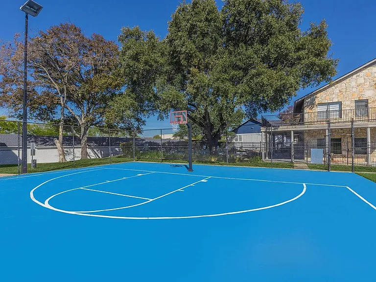 Welcome to Distinction Apartment Homes, where vibrant outdoor spaces await you! Enjoy an energetic lifestyle with our stunning blue sports court perfect for friendly matches and fitness fun. Schedule a tour today and elevate your living experience!