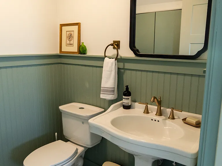The half bathroom is located on the main level by the kitchen and living room