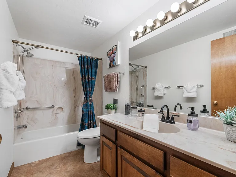 A spacious downstairs full bathroom, located just off Bedroom 2&3 for easy access.