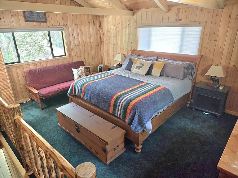 Large bedroom with king size bed and full size futon and half bathroom