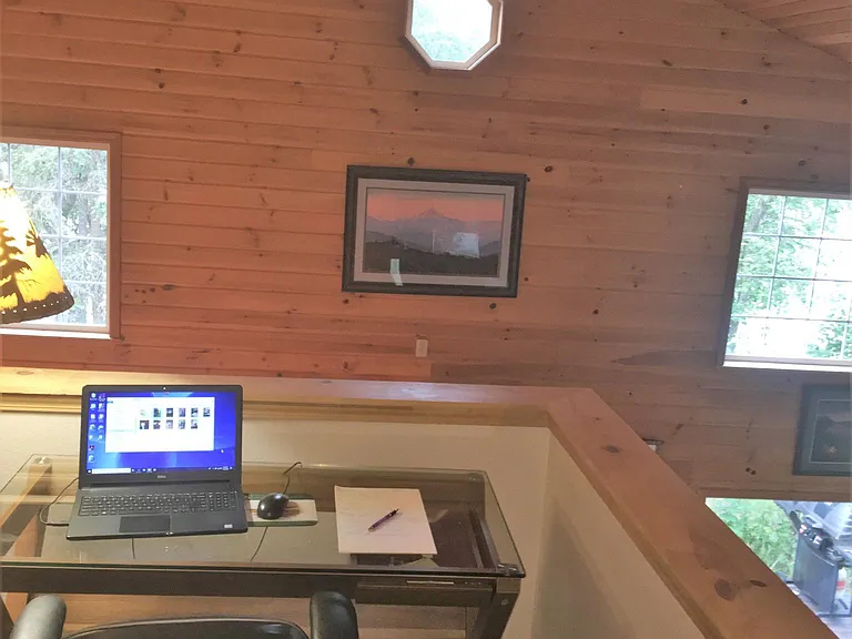 Open loft with desk overlooks dining and living room