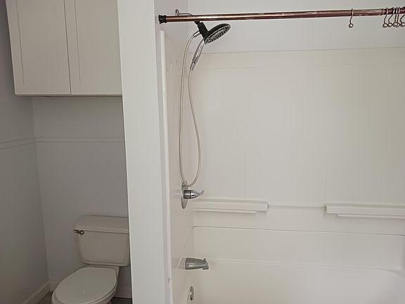 bathroom has tub and shower