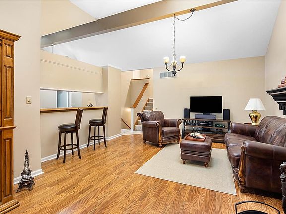 Living room opens to dining room & kitchen. Kitchen features a breakfast bar.
