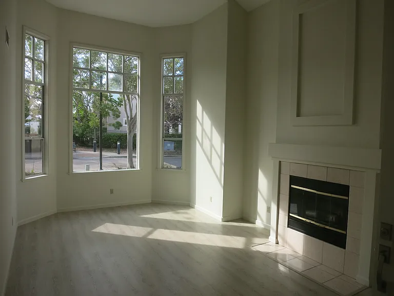 Living room with fireplace and bay windows