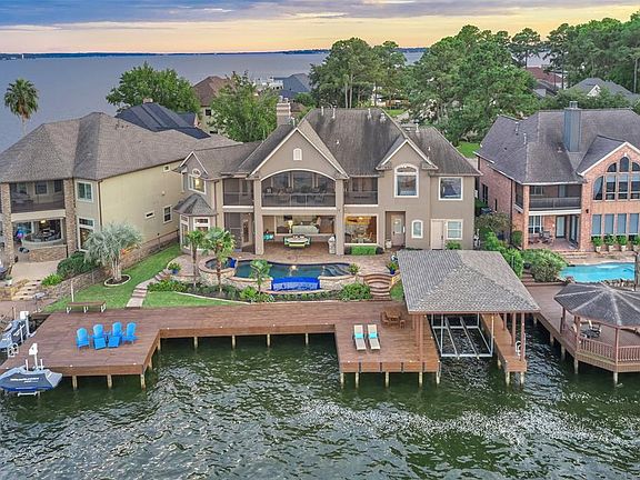 A lake house dream featuring a new 2,000 square foot boathouse & deck, a deep water boat lift, and 2 jet ski lifts.