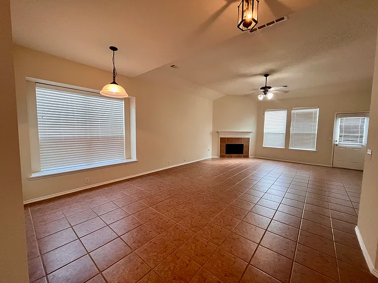 Open space at family and breakfast area with fireplace high ceilings and plenty of natural light