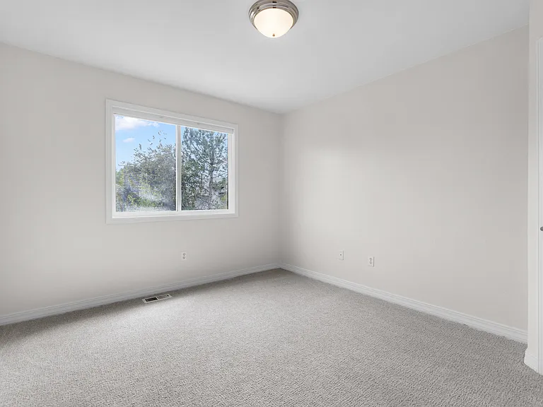 The third bedroom also overlooks the backyard and offers updated carpet, abundant natural light, and a small walk-in closet.