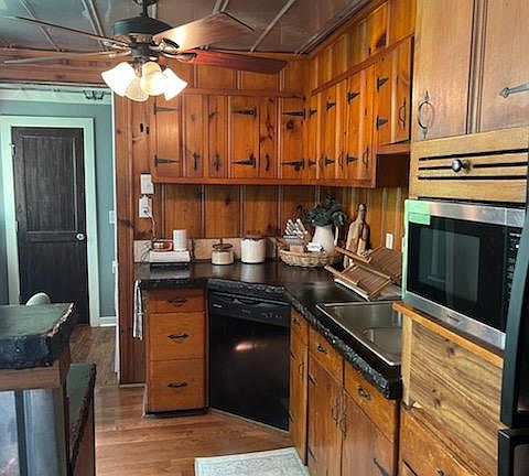 Kitchen with washer dryer room in grey.. Wood door has pantry inside.