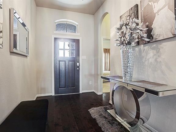 Grand Foyer with wide plank dark wood floors.