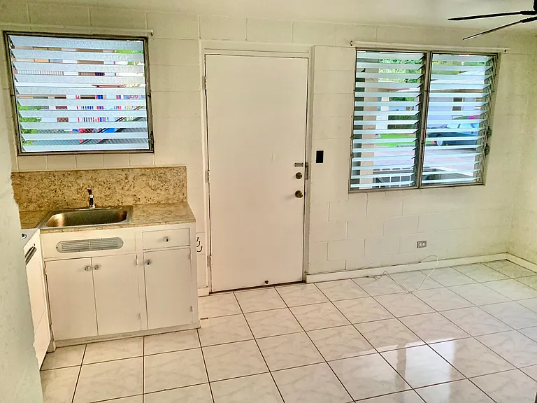 A view of Kitchen connected to the living room by the front door