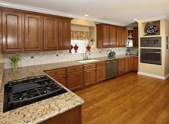 Spacious kitchen with brand new slate appliances!  Beautiful wood floors, tile backsplash and crown molding.