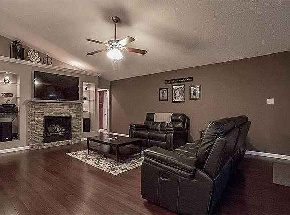 Beautiful Bamboo wood floors and ceiling fan in this great room.