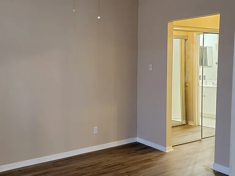 First bedroom with view to closets and 1st bathroom